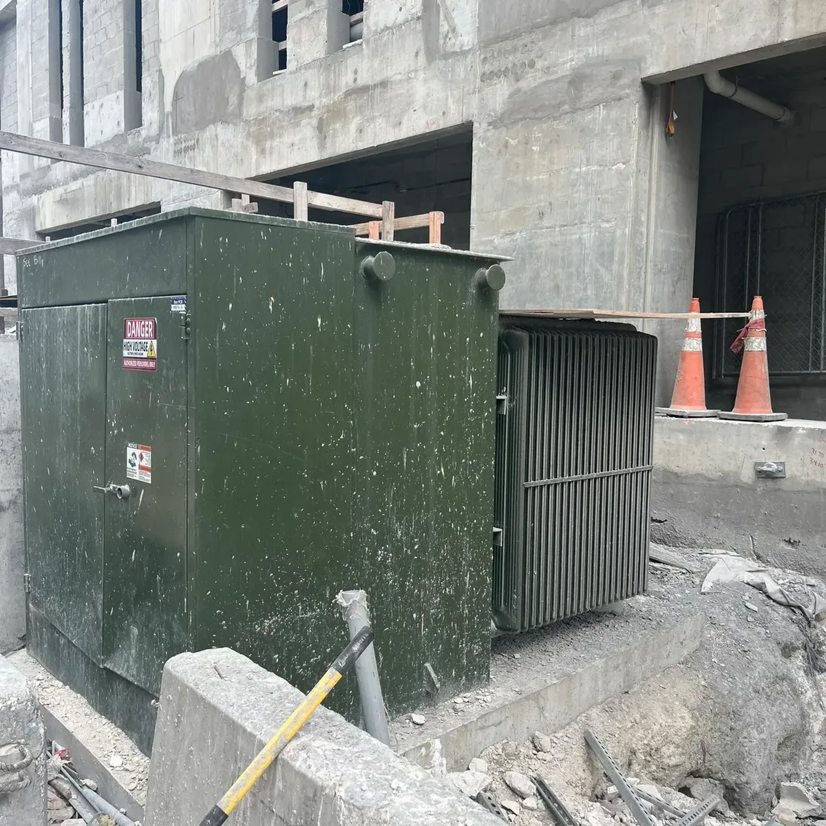 Pad-mount transformer removed on a job site, waiting for pickup
